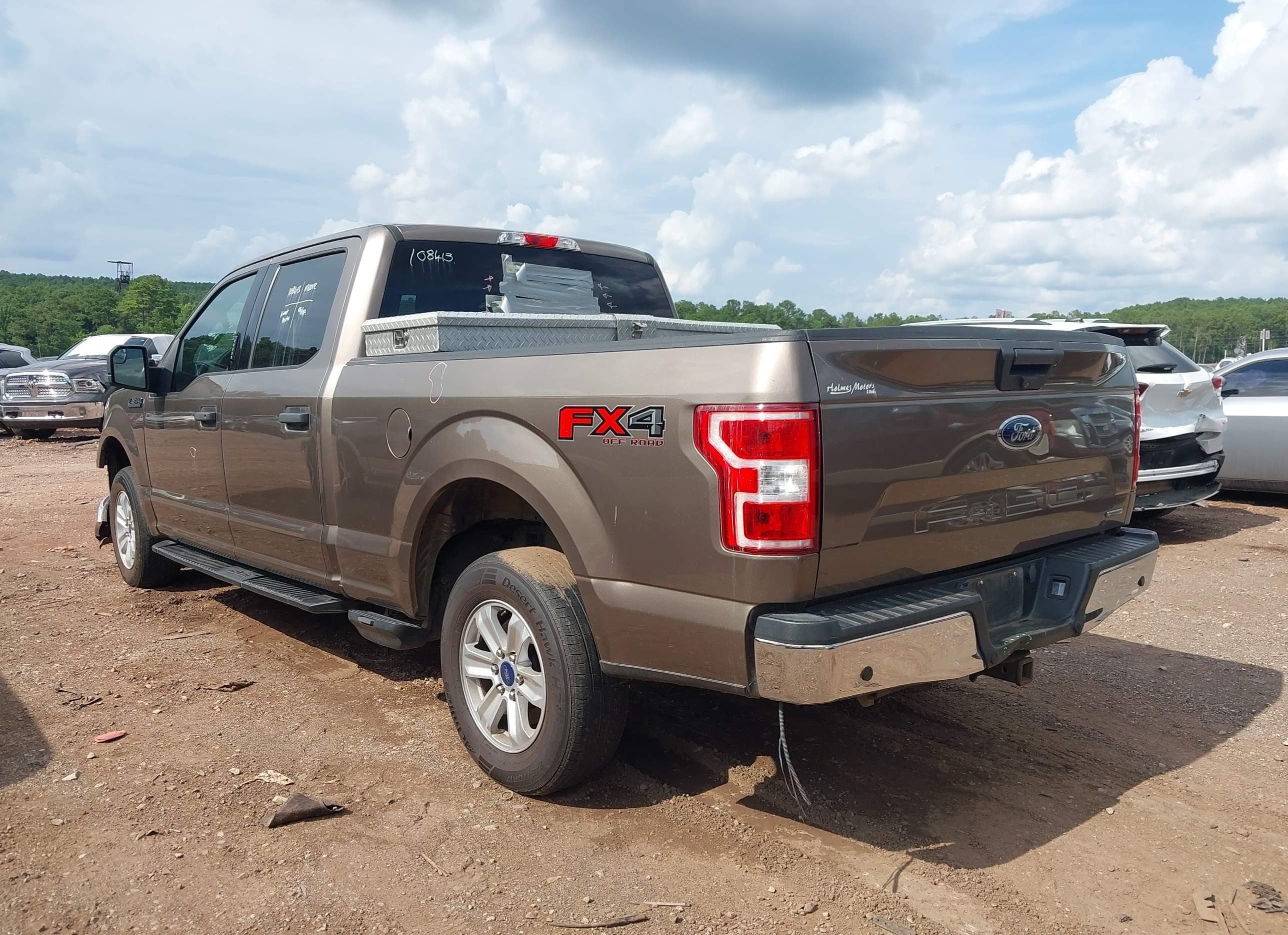 Same 2018 Ford F-150 XLT FX4, rear driver-side three-quarter view — tail lights, tailgate, bed and FX4 Off-Road decal all appear intact