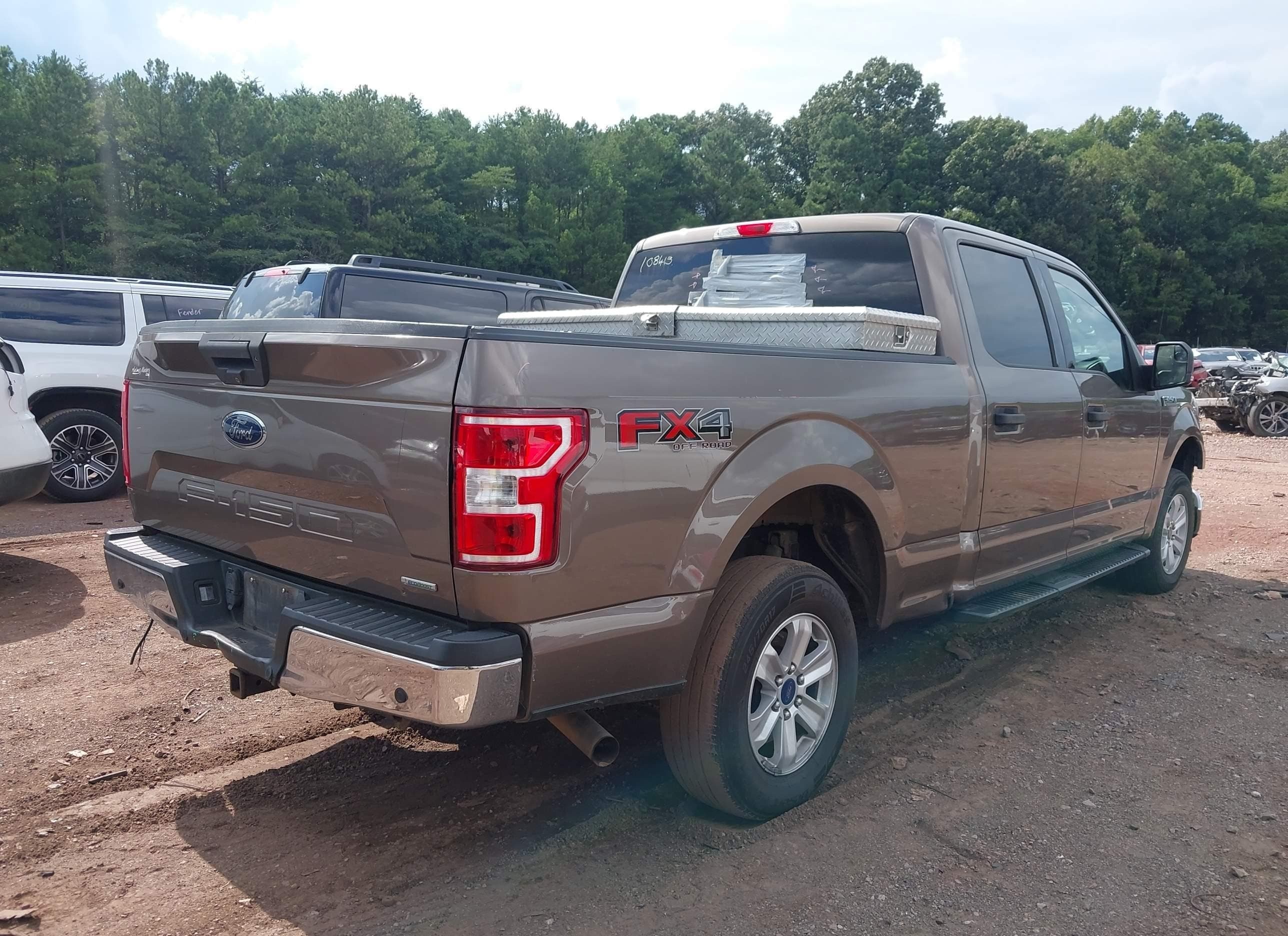 Same 2018 Ford F-150 XLT FX4, rear passenger-side three-quarter view — paint, panels and wheels all look showroom-clean from this angle
