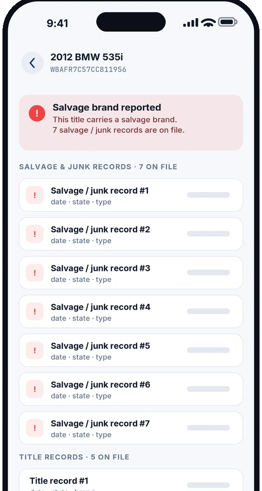 Salvage and title check warning that a salvage brand is reported, with seven salvage and junk records and five title records