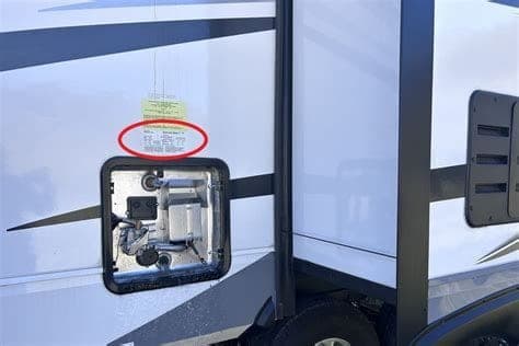 RV interior data plate showing coach VIN and manufacturer information